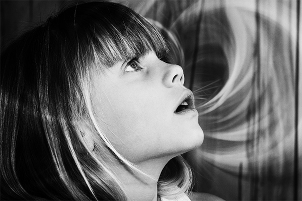 Young girl looking up amazed.