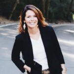 Joanne Johnson standing outside with her hand in the pocket of her jeans.