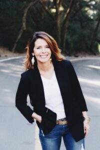 Joanne Johnson standing outside with her hand in the pocket of her jeans.