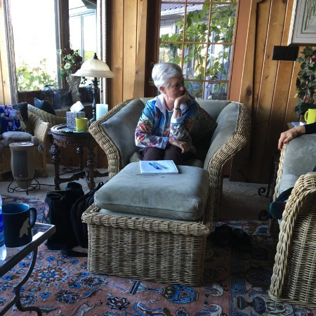 Dr. Anita sitting inside listening to someone.