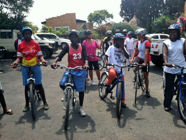 Riders standing on their bikes ready to ride.