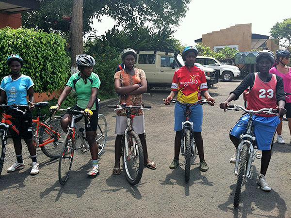 Riders standing on their bikes ready to ride.