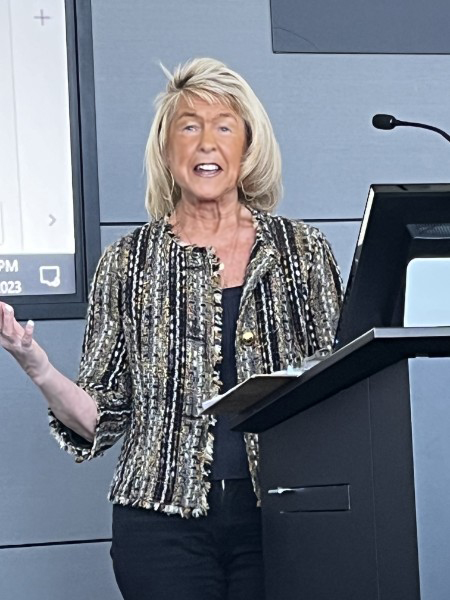 Anastasia standing at the podium during a presentation at Kiwanis.